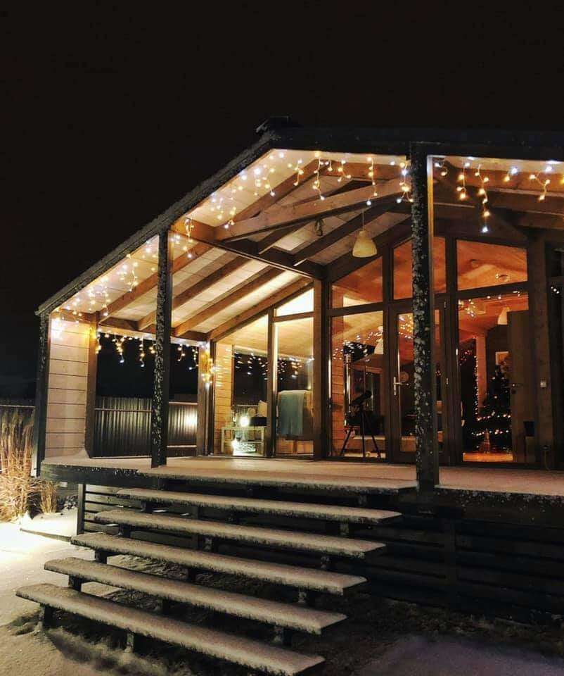 A private Bohemian Homes cabin glowing warmly at night